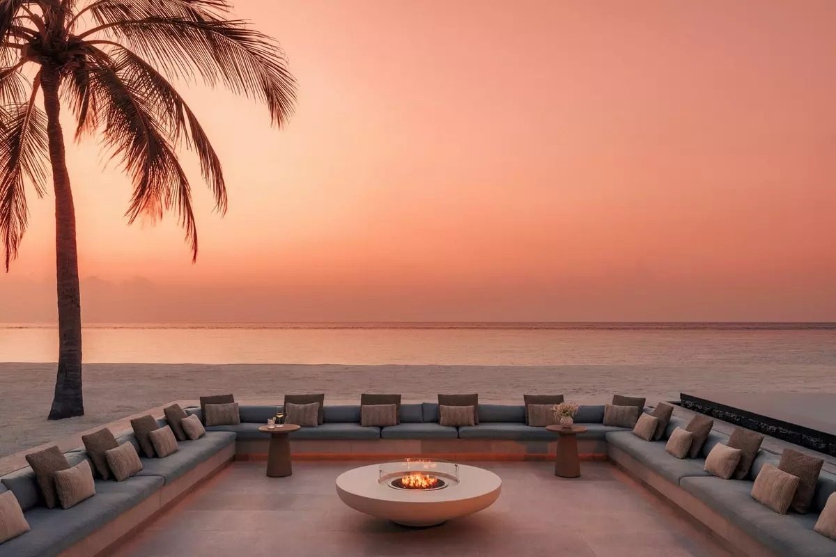 Sunken beachfront lounge with a fire pit at sunset, One&Only Reethi Rah, Maldives